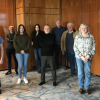 Group of 11 people standing in a carpeted room and wood panelled walls. Mixture of men and women who have formed a group called The Conflict and Legacy Interpretive Network
