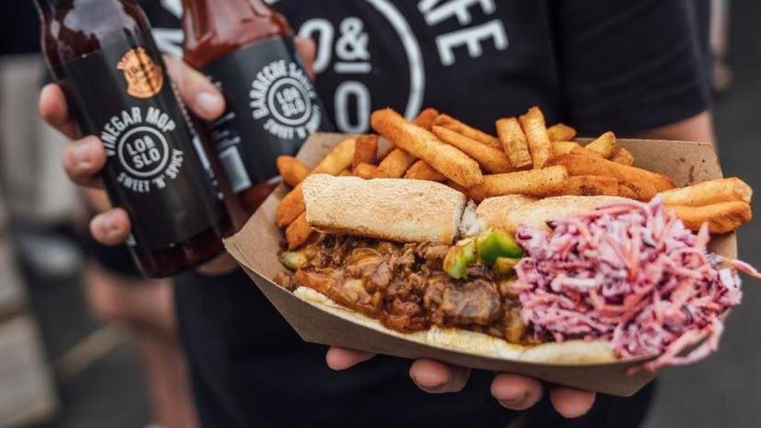 Lo and Slow food including chips, coleslaw and a sloppy joe.