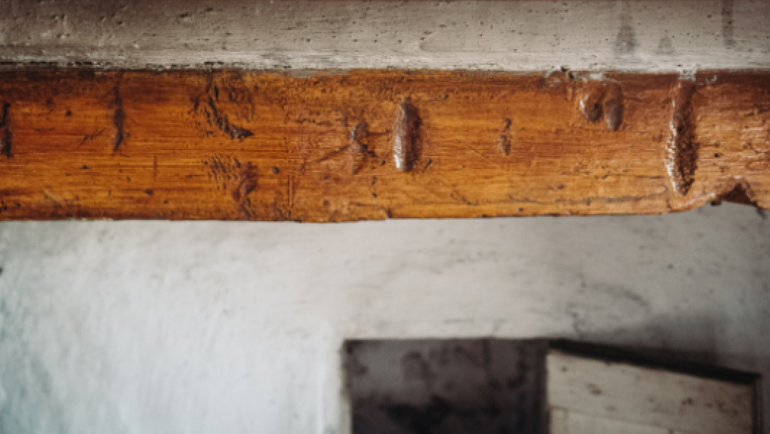 Art on display above fireplace inside exhibition house