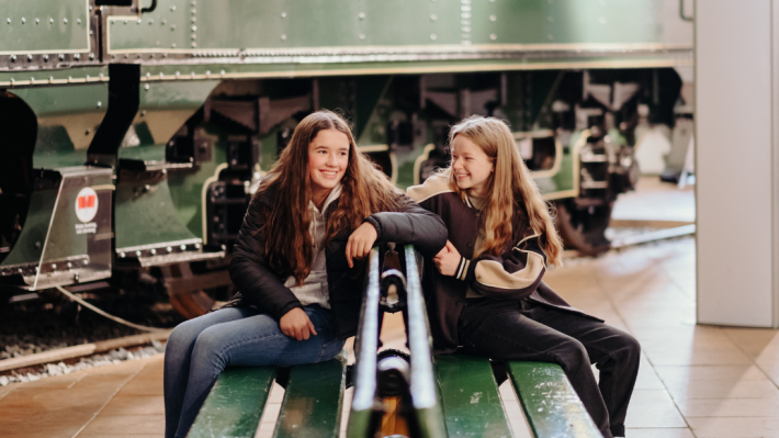 Two girls sat on a bench