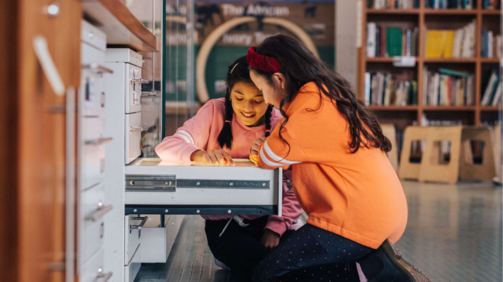 Two girls looking into a drawer, Ulster Museum