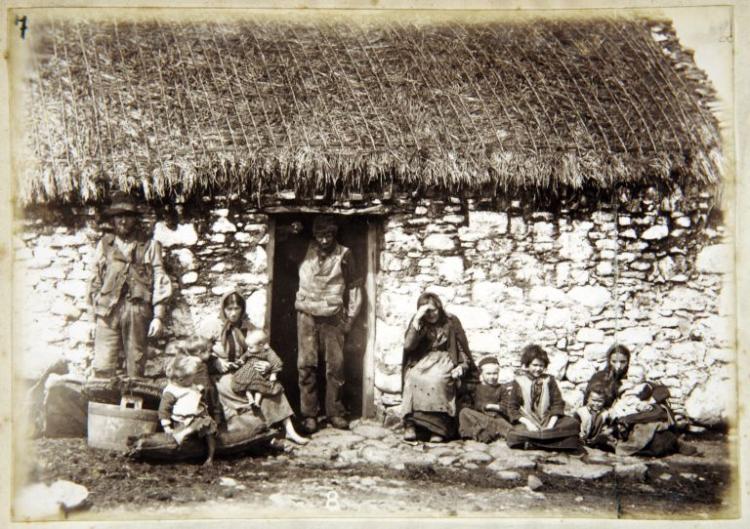 View of Gweedore dwelling with family at the door, black and white photograph