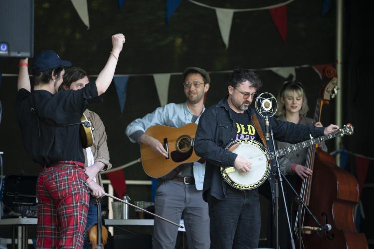 A Bluegrass band enjoying their performance on stage