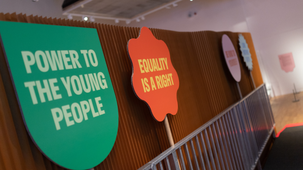 Placards saying Power to the Young People and Equality is a Right displaying in an exhibition at Ulster Museum