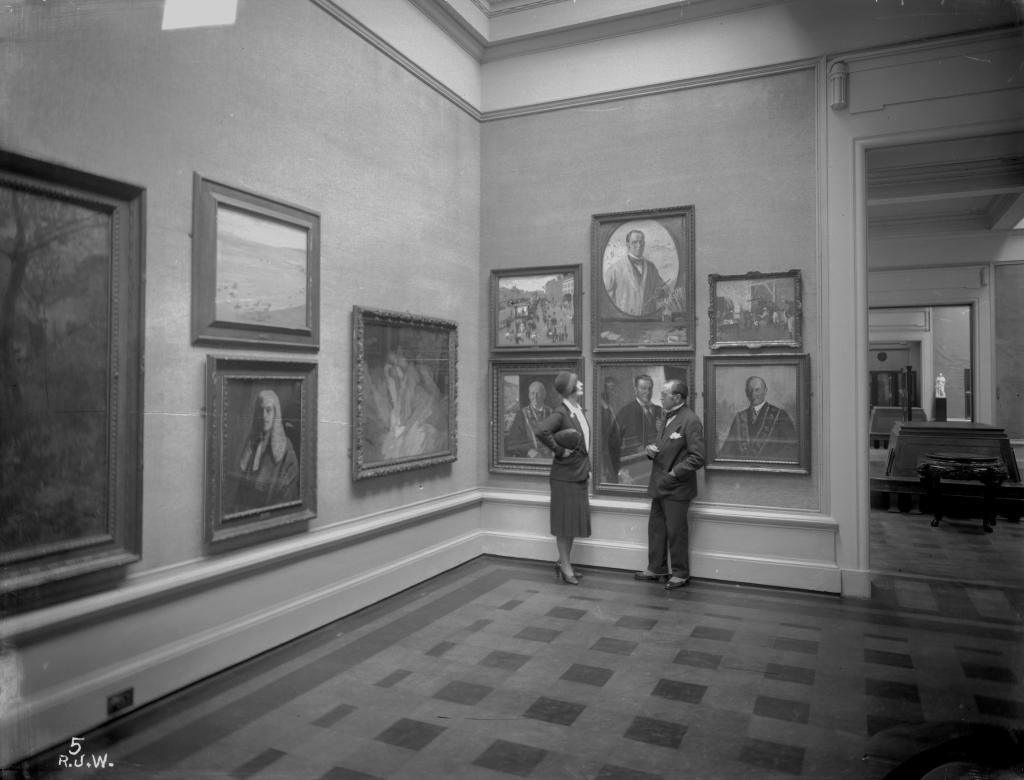 Sir John and Lady Lavery standing in Ulster Museum.