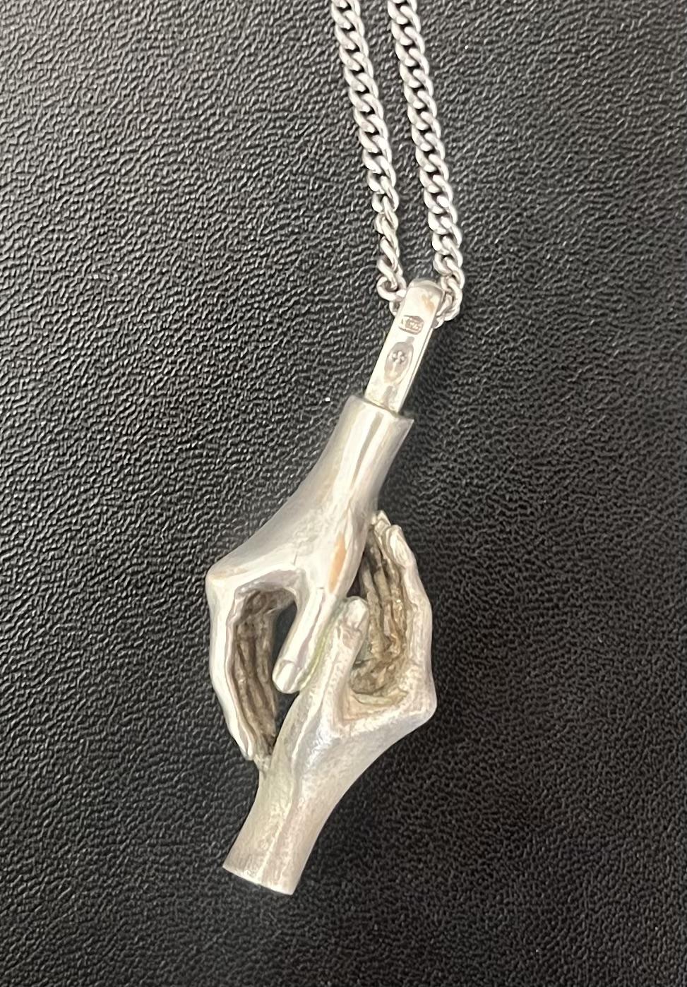 Silver chain with two silver hands, holding