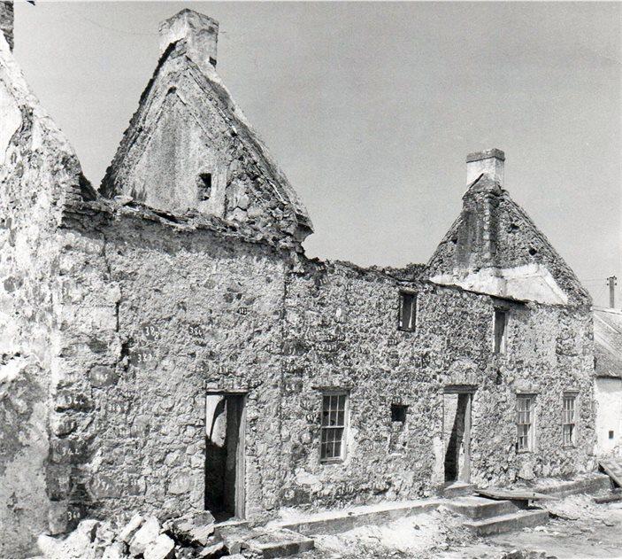 Black and white image of the old rectory building, during transit, brick by brick