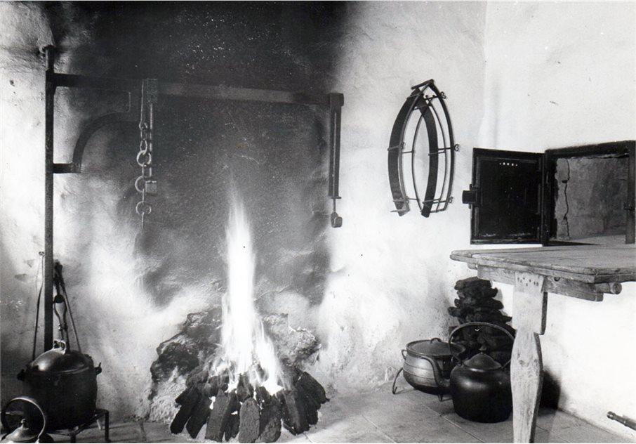 Black and white photograph of a fire and stove inside the Old Rectory building at the Ulster Folk Museum